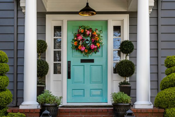 Beautifully,Decorated,Turquoise,Colored,Front,Door,Of,Traditional,Home.,Brick